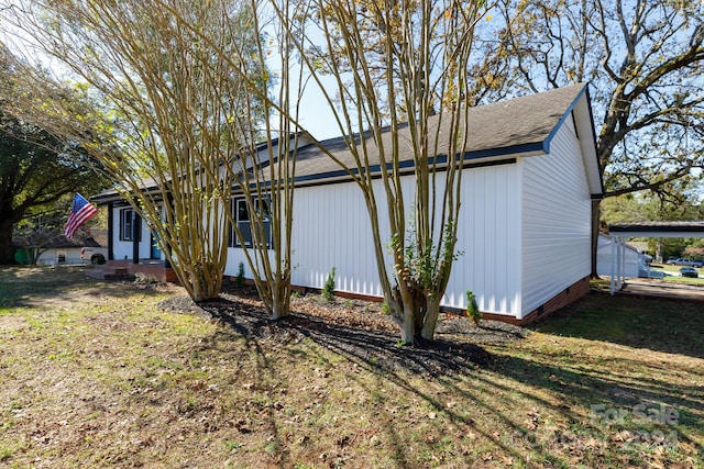 view of side of home featuring a yard