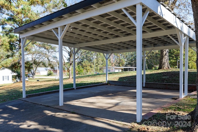 view of car parking featuring a carport and a lawn