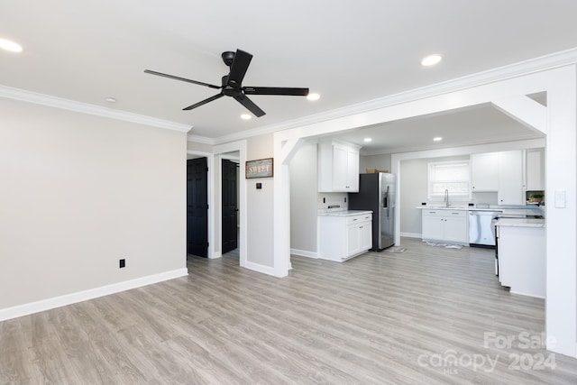 unfurnished living room with light wood-type flooring, sink, crown molding, and ceiling fan