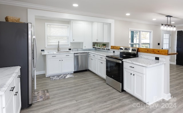 kitchen featuring kitchen peninsula, stainless steel appliances, light wood-type flooring, and light stone countertops