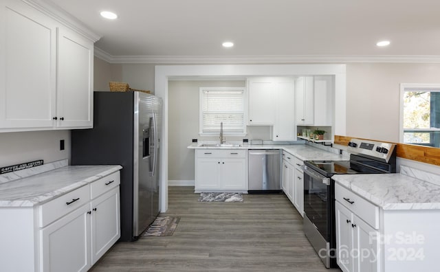 kitchen with stainless steel appliances, sink, dark hardwood / wood-style floors, crown molding, and white cabinets