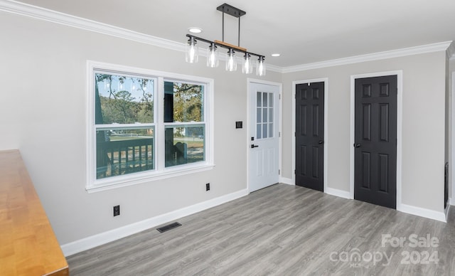 interior space featuring hardwood / wood-style floors and crown molding