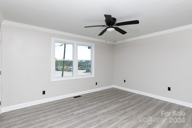 spare room featuring ornamental molding, ceiling fan, and light hardwood / wood-style floors