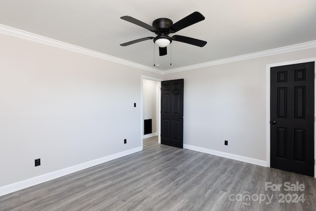 unfurnished bedroom with ceiling fan, light wood-type flooring, and crown molding