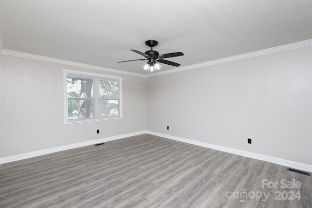 unfurnished room featuring ornamental molding, light wood-type flooring, and ceiling fan