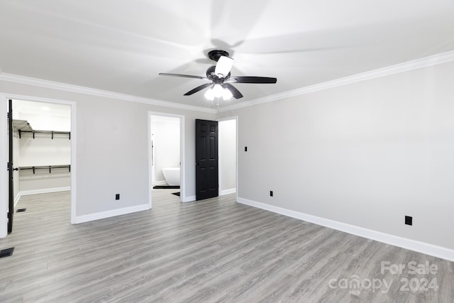 unfurnished bedroom featuring connected bathroom, ornamental molding, ceiling fan, and light hardwood / wood-style flooring