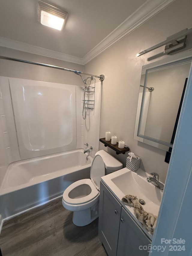 full bathroom featuring hardwood / wood-style flooring, bathing tub / shower combination, ornamental molding, vanity, and toilet