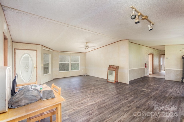 unfurnished living room with dark wood-type flooring, a textured ceiling, and ceiling fan