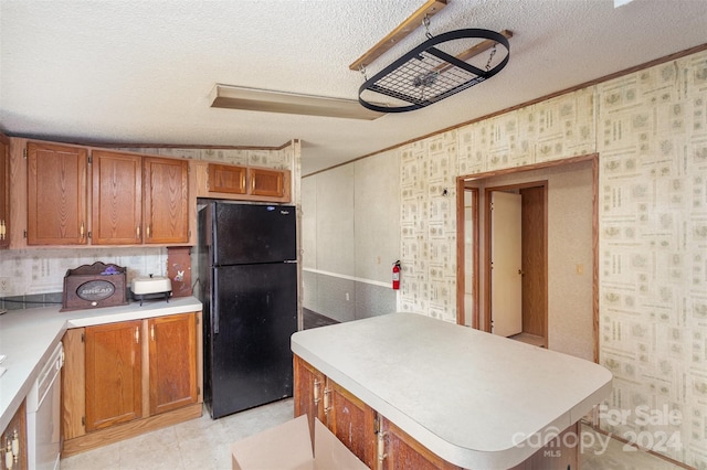 kitchen featuring lofted ceiling, black refrigerator, dishwasher, a textured ceiling, and a kitchen island