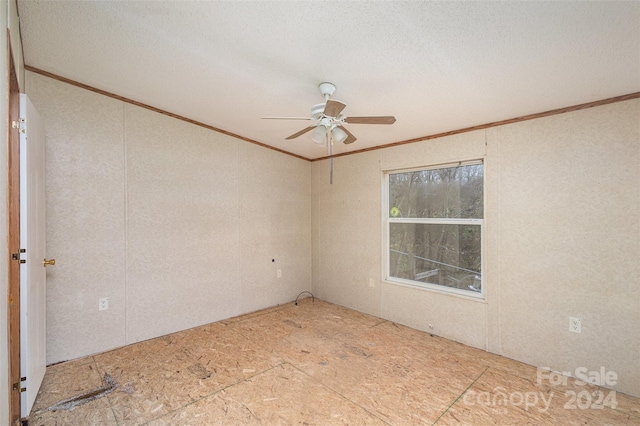 spare room with ceiling fan, a textured ceiling, and crown molding