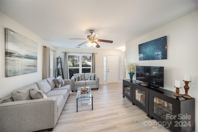 living room featuring light hardwood / wood-style flooring and ceiling fan