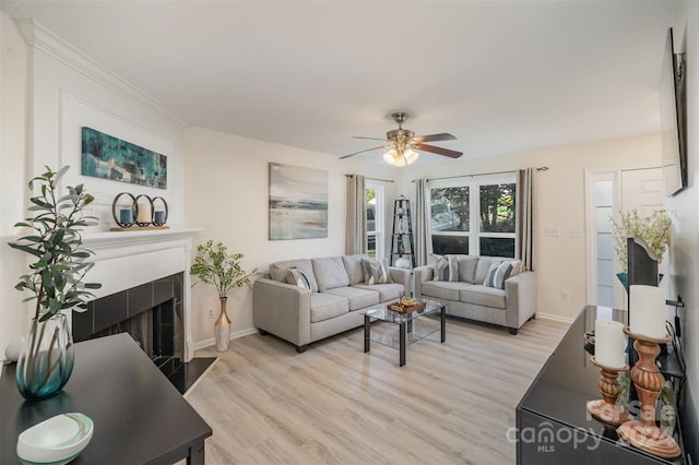 living room featuring ceiling fan and light hardwood / wood-style flooring