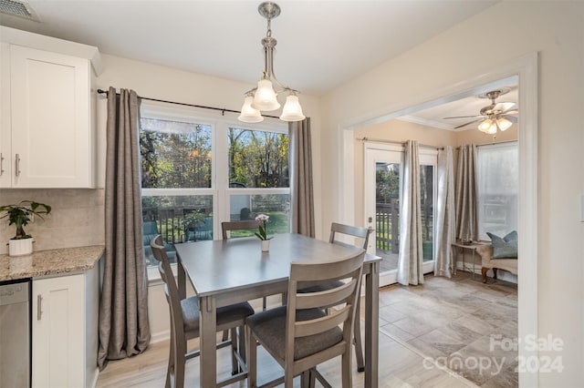 dining room featuring ceiling fan with notable chandelier, light hardwood / wood-style floors, and crown molding