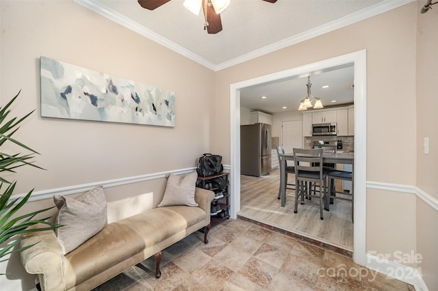 interior space with a textured ceiling, ornamental molding, and ceiling fan with notable chandelier