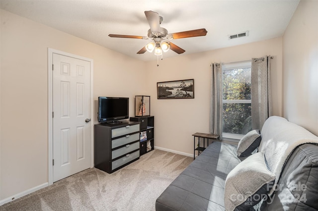 carpeted living room featuring ceiling fan