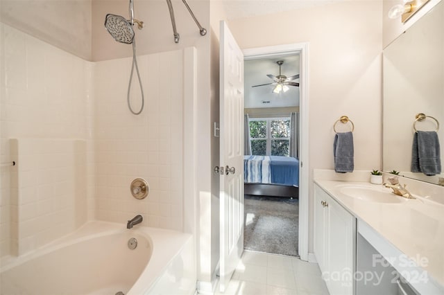 bathroom with tile patterned flooring, vanity, tiled shower / bath combo, and ceiling fan