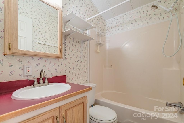 full bathroom featuring toilet, vanity, and  shower combination