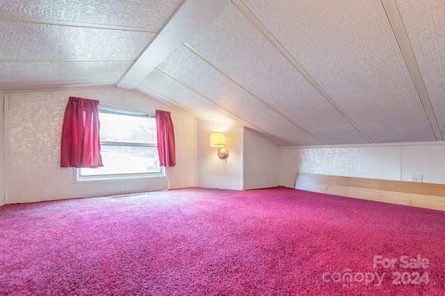 additional living space with lofted ceiling and carpet