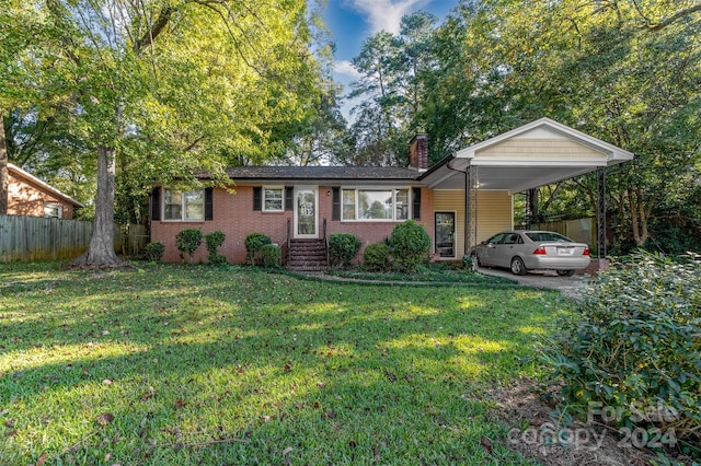 ranch-style house featuring a front yard and a carport