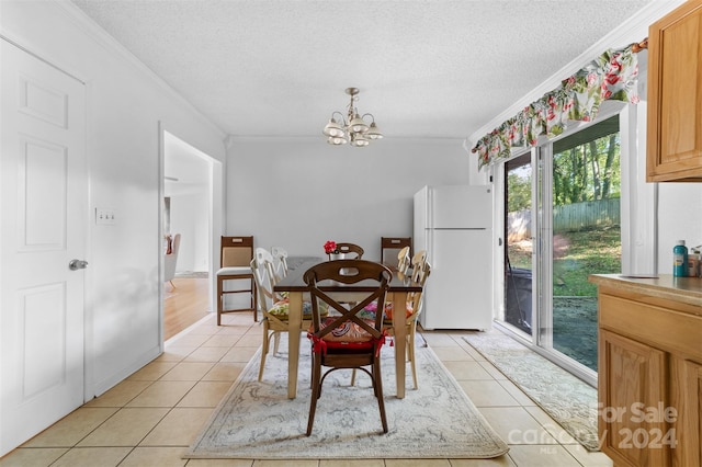 tiled dining room with ornamental molding, a chandelier, and a wealth of natural light