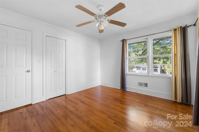 unfurnished bedroom with hardwood / wood-style flooring and ceiling fan