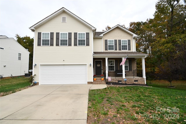 view of front of house featuring a porch, a front lawn, and a garage