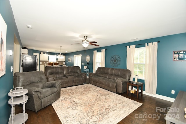 living room with ceiling fan and dark hardwood / wood-style flooring