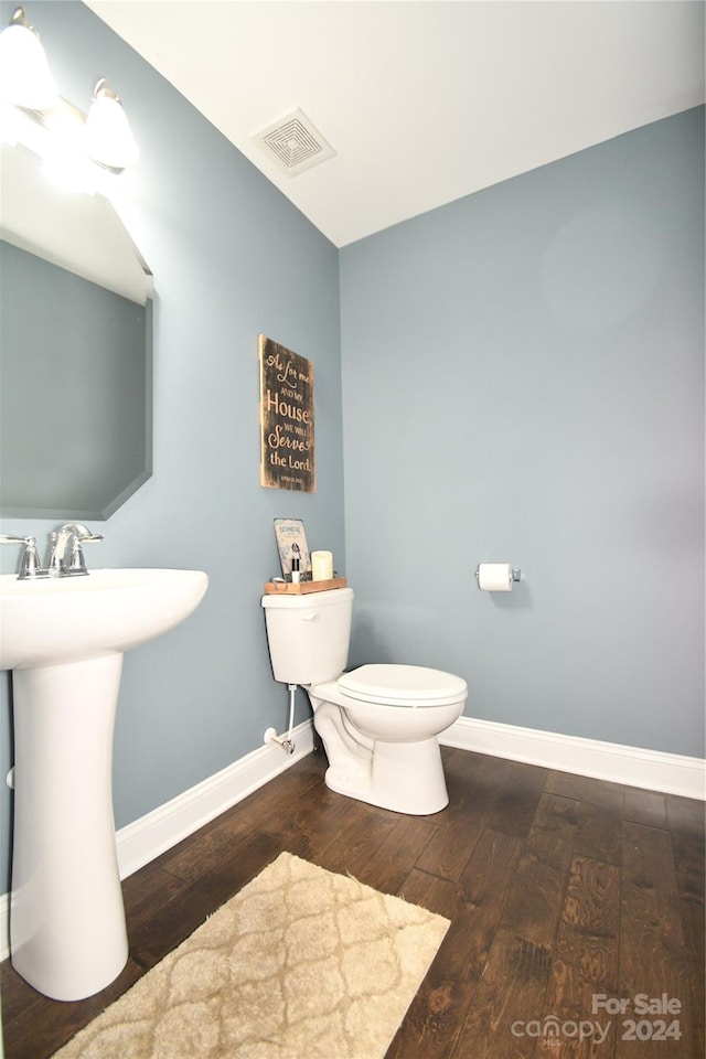 bathroom featuring toilet, hardwood / wood-style flooring, and sink