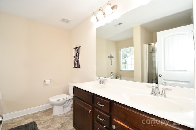 bathroom featuring vanity, toilet, and an enclosed shower