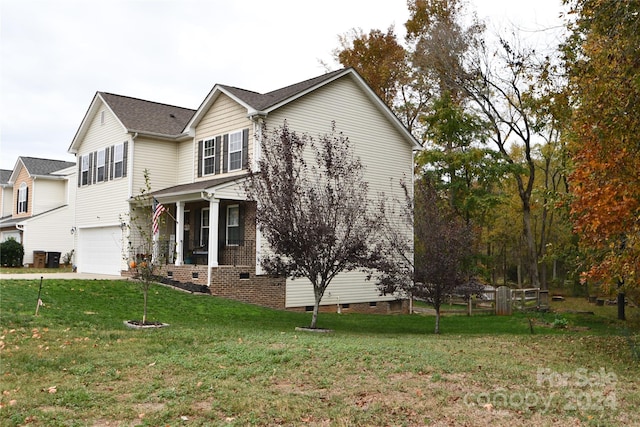 view of front of property with a front yard and a garage