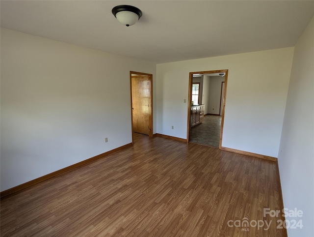 empty room featuring dark wood-type flooring