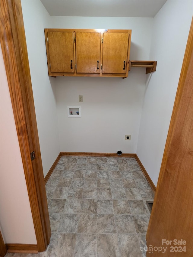 washroom featuring hookup for an electric dryer, washer hookup, and cabinets