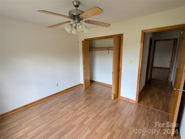 unfurnished bedroom with a closet, light hardwood / wood-style floors, and ceiling fan