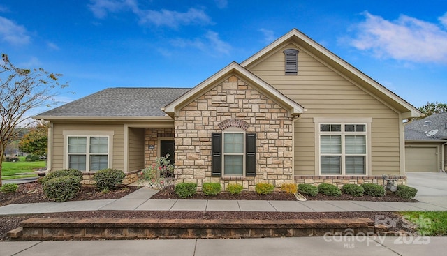 4919 Polo Gate Blvd, Charlotte, NC 28216 - view of front of home featuring stone siding, roof with shingles, and a garage