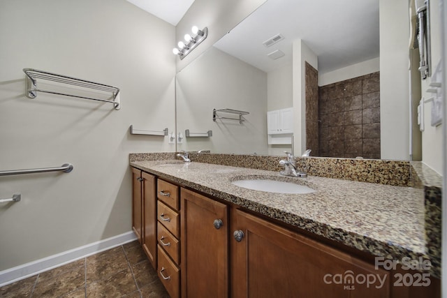 4919 Polo Gate Blvd, Charlotte, NC 28216 - full bath featuring baseboards, double vanity, and stone tile flooring