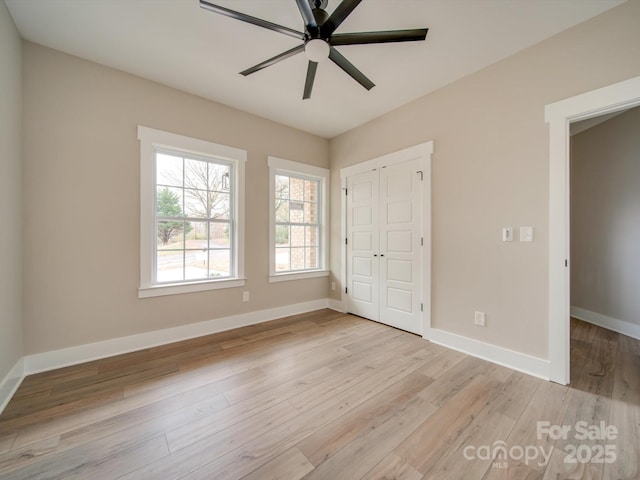 unfurnished bedroom featuring ceiling fan, a closet, and light hardwood / wood-style floors