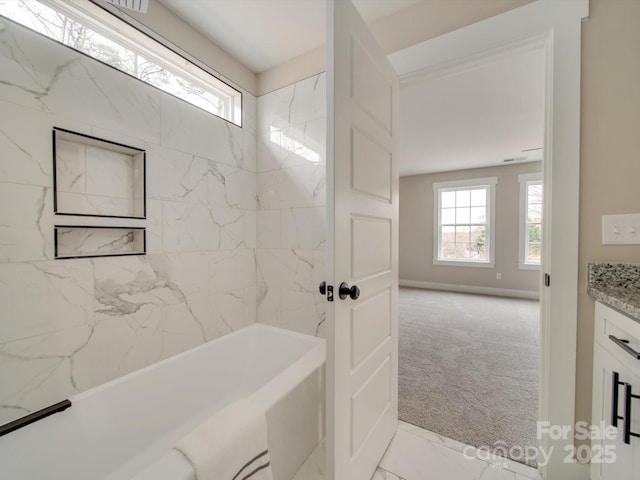 bathroom with tiled shower / bath and vanity