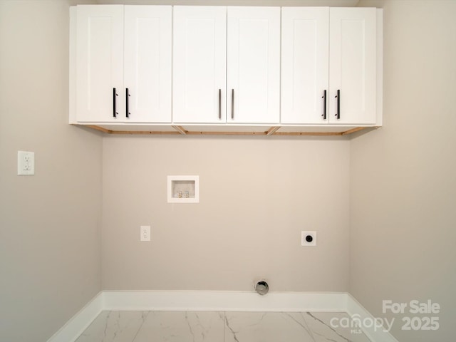 washroom with hookup for a washing machine, cabinets, and electric dryer hookup