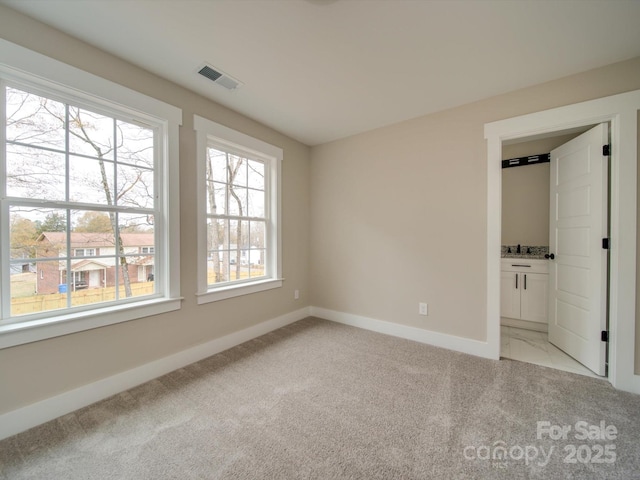 unfurnished bedroom with light colored carpet