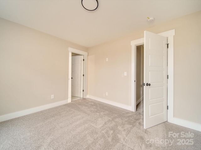 spare room featuring light colored carpet