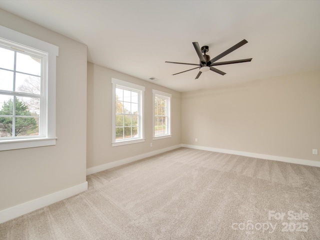 carpeted spare room featuring ceiling fan