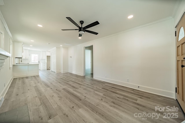 unfurnished living room with ceiling fan, light wood-type flooring, and crown molding