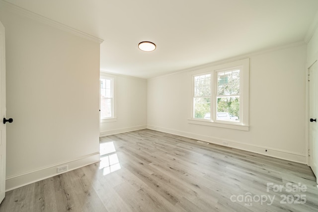 unfurnished room with light hardwood / wood-style flooring and ornamental molding