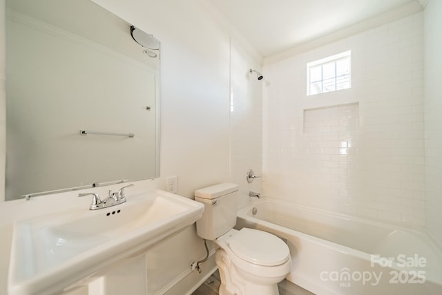 full bathroom featuring ornamental molding, sink, tub / shower combination, and toilet