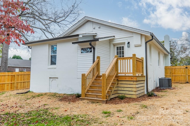 rear view of property featuring central AC unit