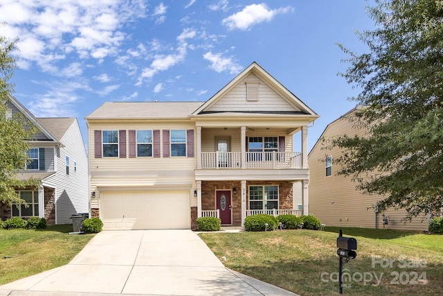 view of front of property featuring a porch, a garage, a balcony, and a front lawn