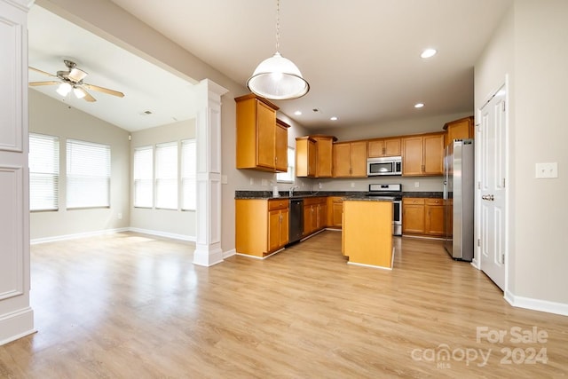 kitchen with pendant lighting, a center island, light wood-type flooring, and appliances with stainless steel finishes