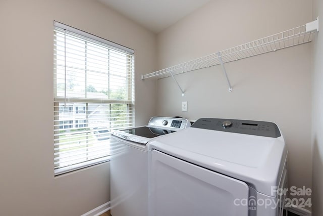 laundry room with a healthy amount of sunlight and independent washer and dryer