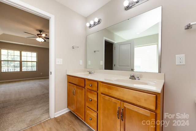 bathroom with hardwood / wood-style floors, ceiling fan, and vanity