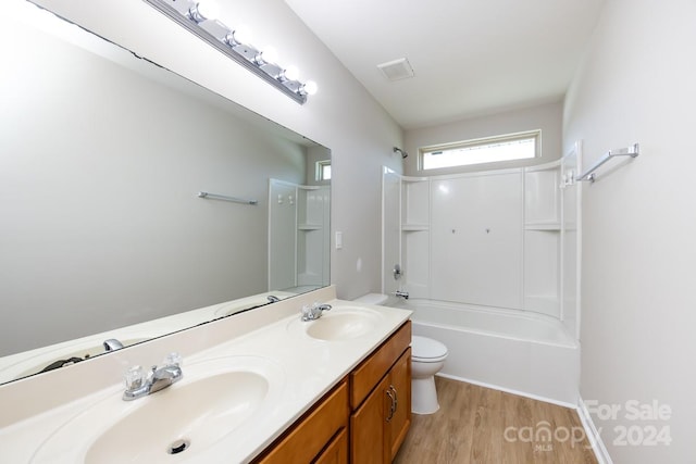 full bathroom with hardwood / wood-style flooring, vanity, toilet, and shower / bathing tub combination